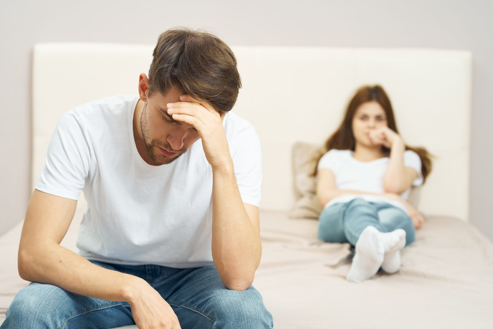 Eternal Health Solutions - Frustrated couple sitting on the bed